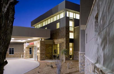 Picture of hospital building entrance at night.